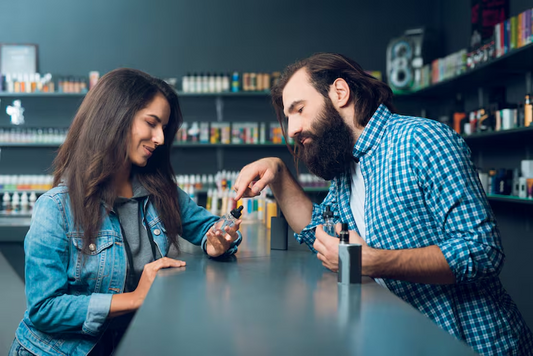 Man showing woman a vape
