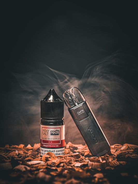 Vape in Leather Case Resting against Liquid Bottle